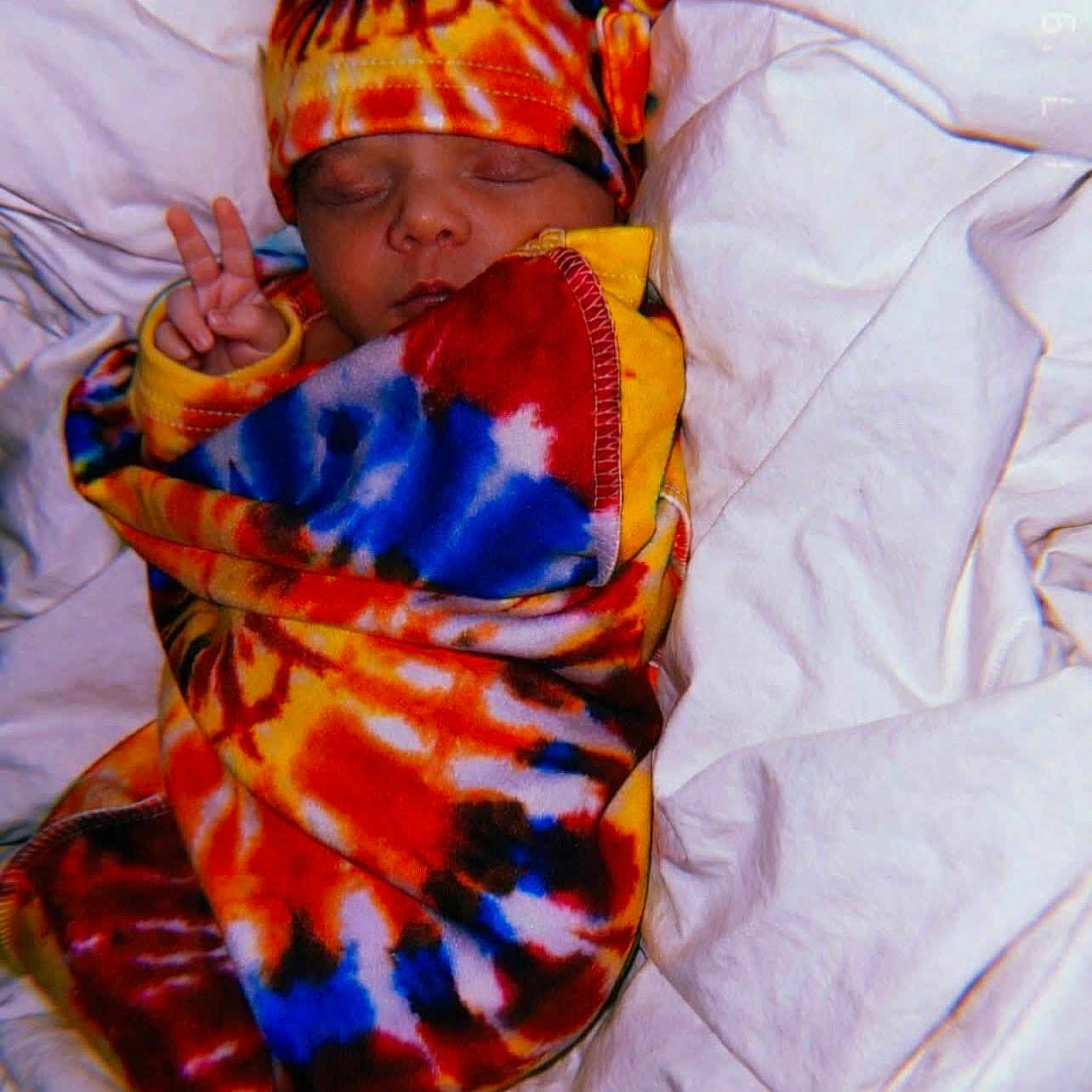 Sophia is registered to the contest to win money with this photo: baby, bed, bedding, blanket, child, colorful, cozy, cute, hat, infant, newborn, peace_sign, peaceful, portrait, rest, sleeping, soft, tie_dye, warm, wrapped