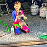 Sprocket joined the competition — help win amazing prizes! boy, colorful_clothing, concrete_floor, dog, garage, gloves, indoor, kneeling, leash, motocross_gear, motorcycle, pet, playful, propane_tank, puppy, smiling, sunlight, tools, water_bottle, young_child