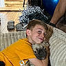 Sprocket joined the competition — help win amazing prizes! boy, casual, child, couch, cozy, dog, exercise_ball, face, floor, footwear, happy, home, hug, indoor, orange_shirt, pet, plush, pug, smile, wooden_wall
