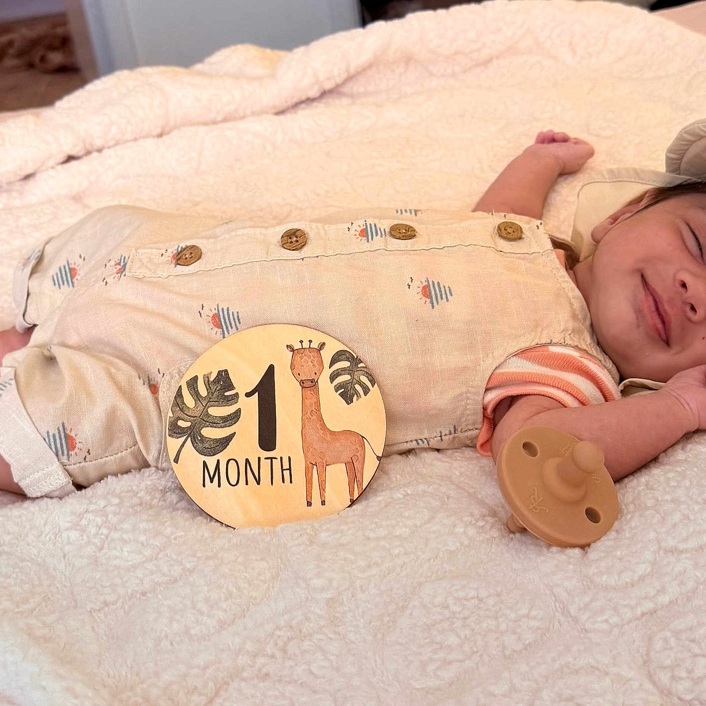 Audi joined the competition — help win amazing prizes! baby, blanket, child, clothing, cute, giraffe, hat, indoor, infant, milestone, newborn, one_month, pacifier, peaceful, portrait, resting, sleeping, smiling, soft_texture, wooden_sign