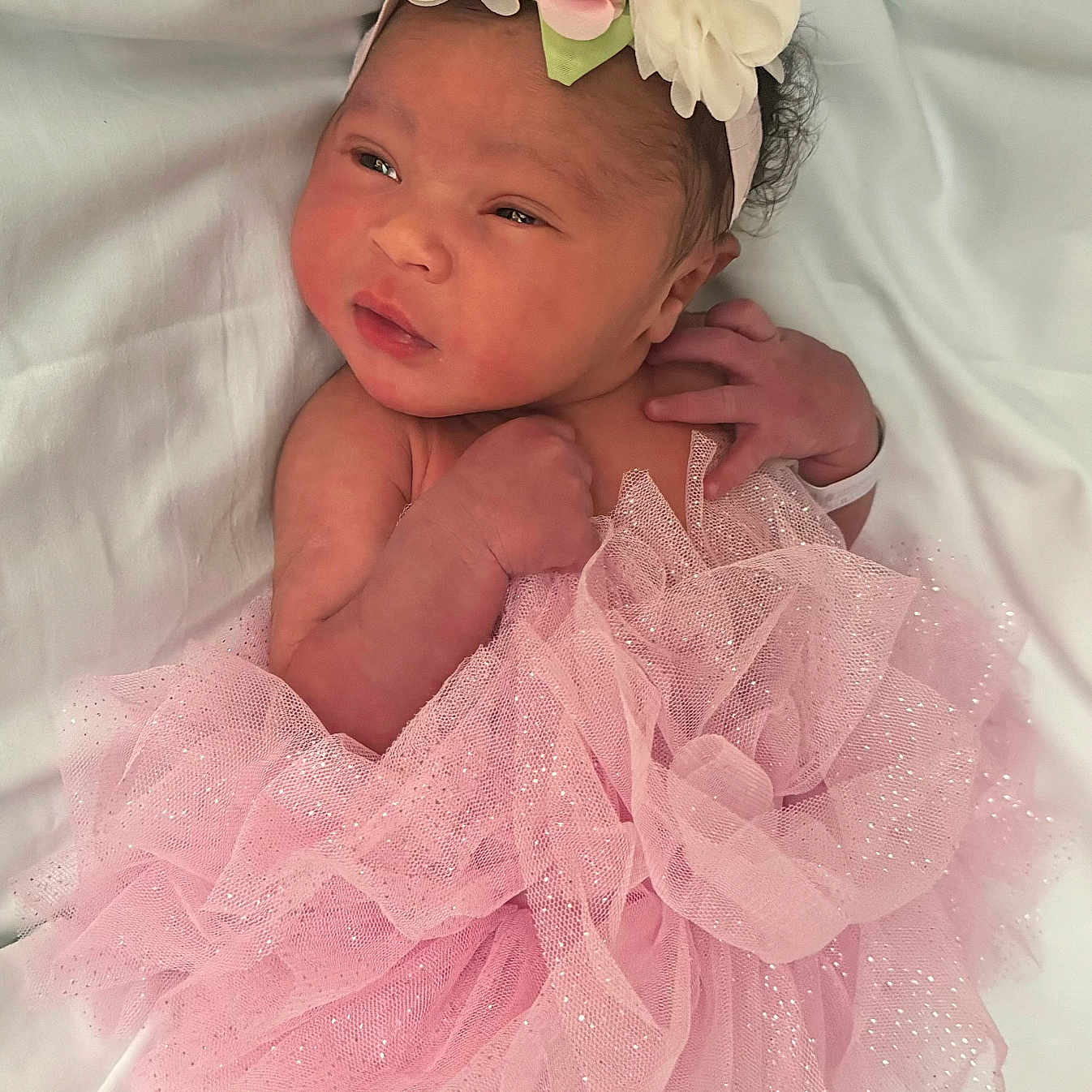 Indi is registered to the contest to win money with this photo: accessories, baby, bodypart, clothing, dress, face, finger, flower, flowerarrangement, flowerbouquet, formalwear, hand, hat, head, newborn, person, petal, photography, plant, portrait