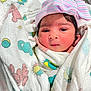 Swaha is registered to the contest to win money with this photo: newborn, baby, infant, wrapped, blanket, hat, bow, striped, pink, blue, cute, face, eyes, skin, hand, clothing, cute_baby, indoors, portrait, closeup