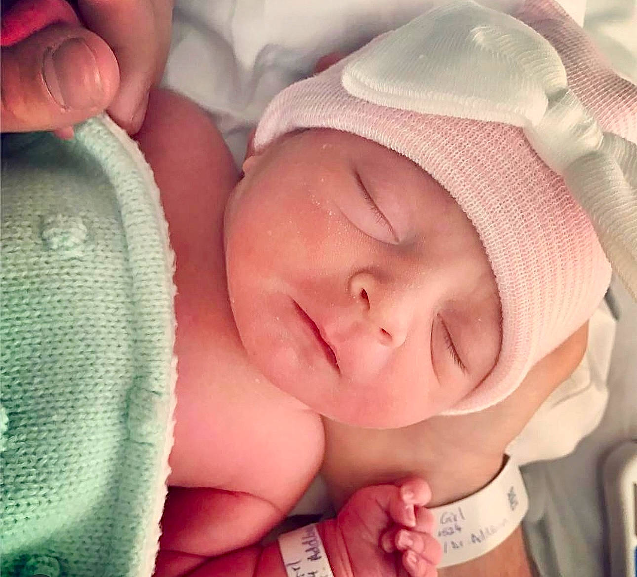 Hayden is registered to the contest to win money with this photo: arm, baby, baby_sleeping, cheek, chin, comfort, ear, eye, eyebrow, eyelash, face, facial_expression, hand, head, headwear, human_body, lip, mouth, nose, person