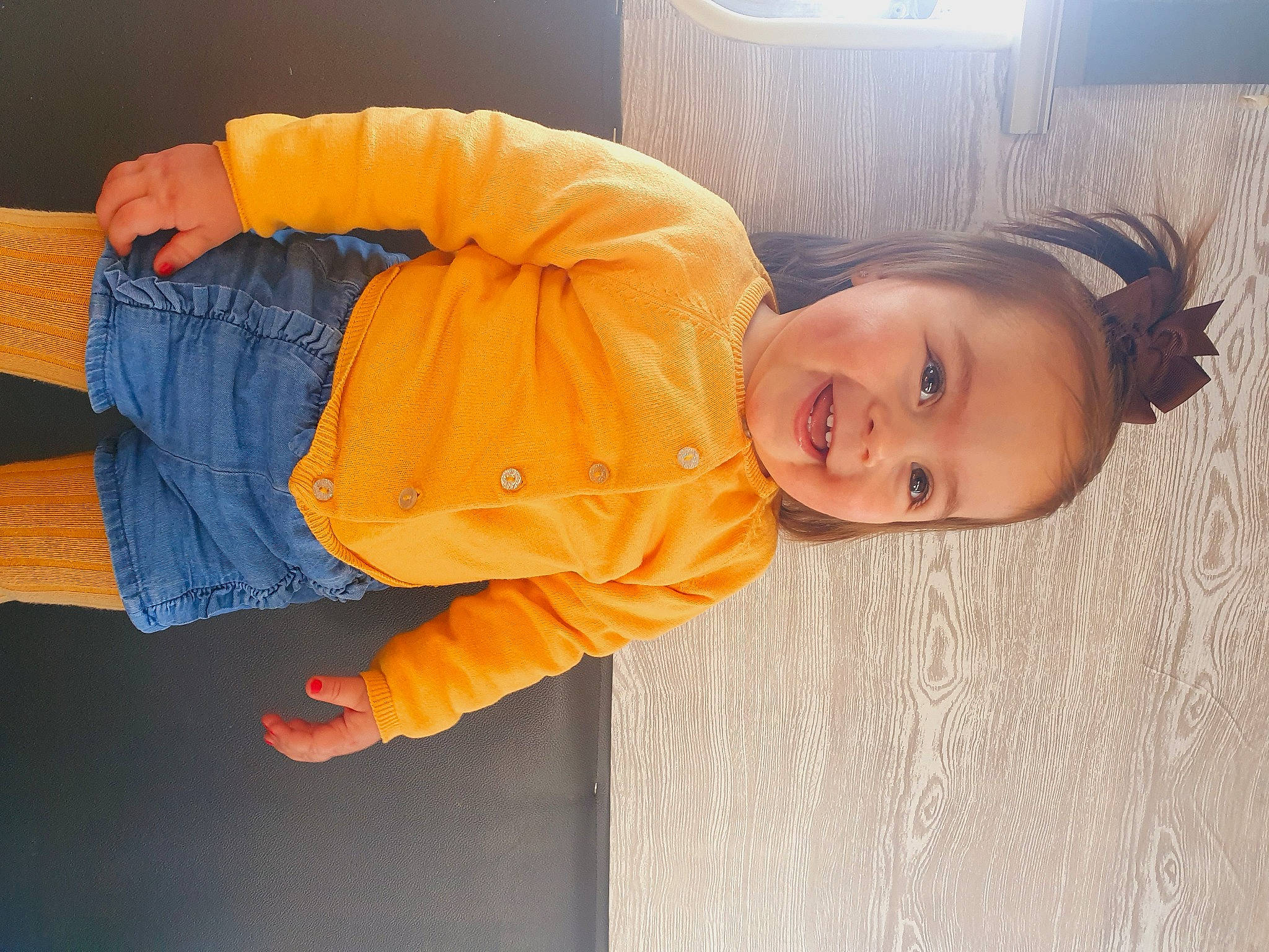 Rose a rejoint le concours — aidez-le/la à gagner de superbes lots ! baby_toddler_clothing, cheek, child, comfort, eye, flooring, fun, happy, head, jacket, joy, nose, orange, person, sitting, sleeve, smile, toddler, tree, wood