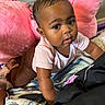Ailani is registered to the contest to win money with this photo: baby, child, infant, crawling, portrait, face, eyes, curious, indoors, bed, blanket, pillow, pink, clothing, onesie, sitting, home, bedroom, photography, adorable