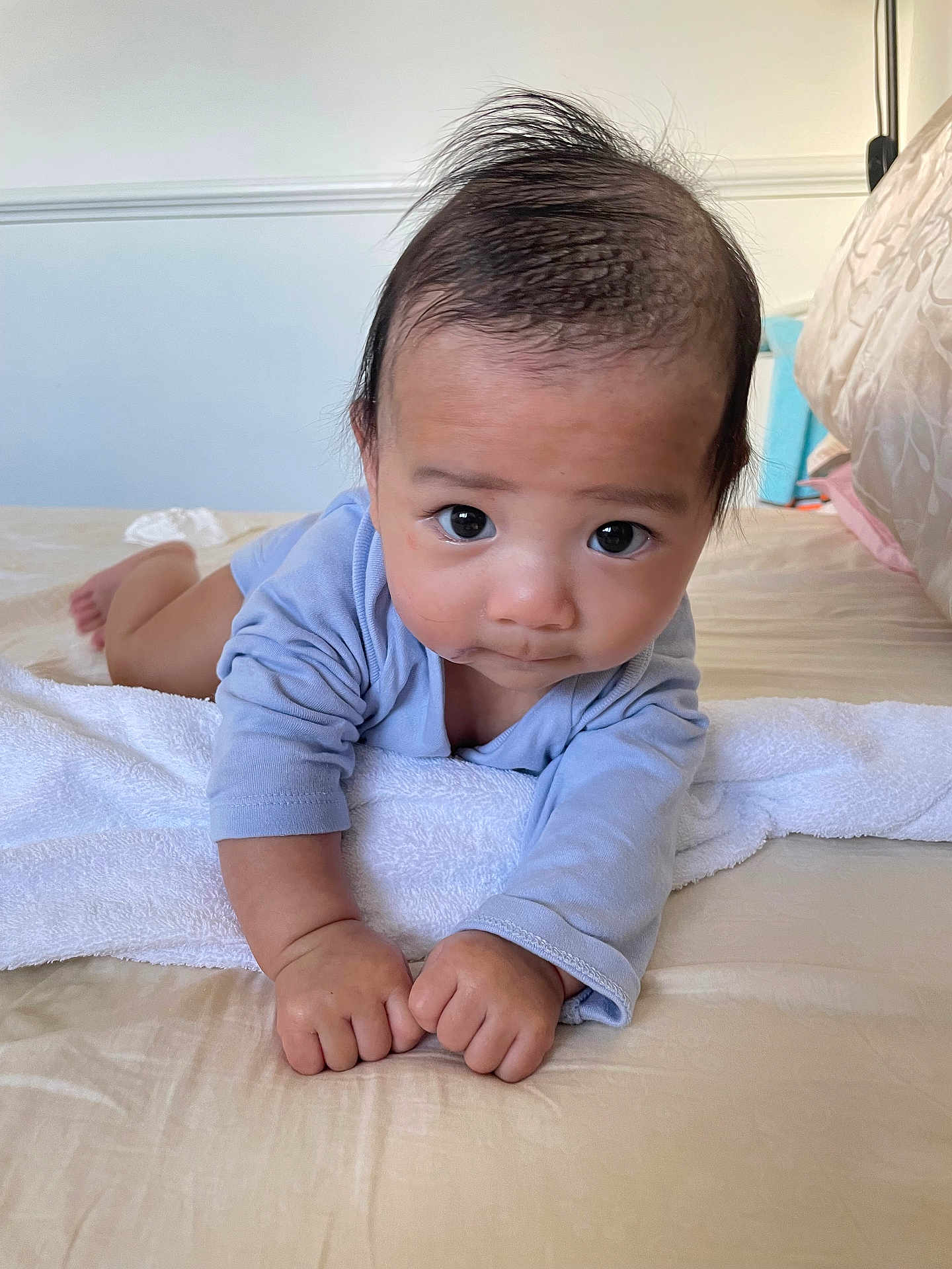 Gumatz joined the competition — help win amazing prizes! baby, infant, tummy_time, bed, towel, blue_clothing, indoor, person, child, cute, young, skin, hair, hands, face, eyes, expression, furniture, home, rest