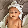 baby, infant, towel, diaper, bed, blanket, cute, face, eyes, skin, headwear, soft, expression, child, laying, indoors, person, newborn, toddler, portrait