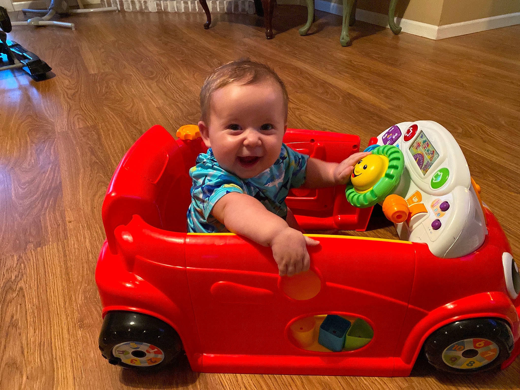 Axton is registered to the contest to win money with this photo: baby, baby_playing_with_toys, baby_toddler_clothing, car, child, fun, happy, leisure, motor_vehicle, person, photograph, product, red, riding_toy, smile, snapshot, tire, toddler, toy, vehicle