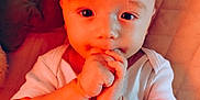 Louie joined the competition — help win amazing prizes! adorable, baby, child, close_up, cute, expression, eyes, face, hands, hat, indoors, infant, knit_hat, lying_down, plush_toys, portrait, quilted_bed, skin, soft_lighting, white_onesie