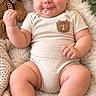 baby, infant, child, smiling, portrait, lying_down, teddy_bear, stuffed_animal, blanket, fluffy_blanket, onesie, sandals, wooden_sign, nursery, cozy, indoor, close_up, happy, brown_tones, baby_photography
