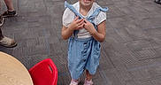 Emma joined the competition — help win amazing prizes! background, blue_dress, carpet, chair, child, classroom, cute, education, floor, furniture, girl, happy, indoor, person, pigtails, pink_shoes, school, smiling, table, young