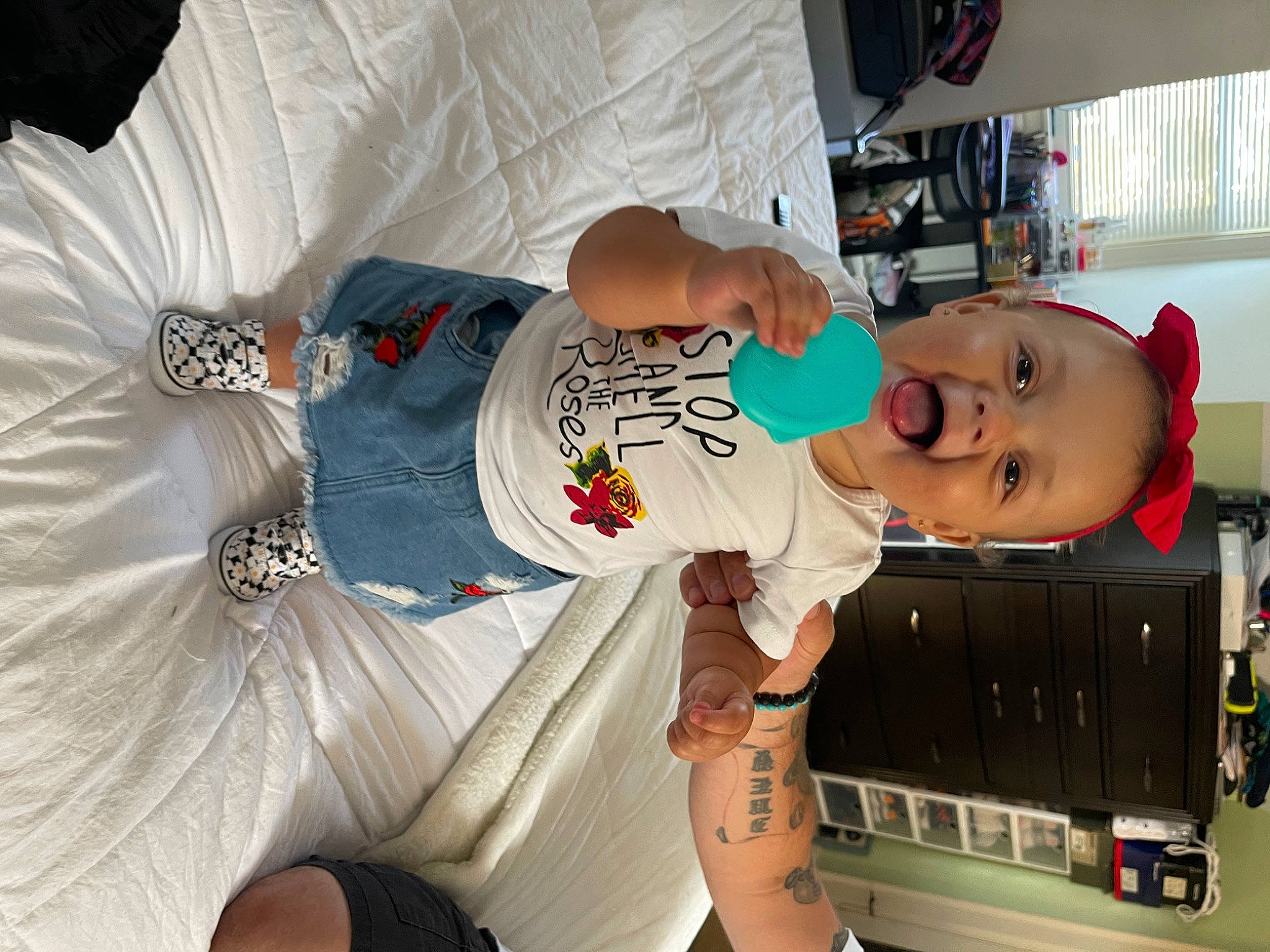 Aliyah is registered to the contest to win money with this photo: baby, baby_products, baby_toddler_clothing, child, comfort, cool, elbow, fun, human_leg, mouth, person, room, sitting, sleeve, t_shirt, thigh, toddler
