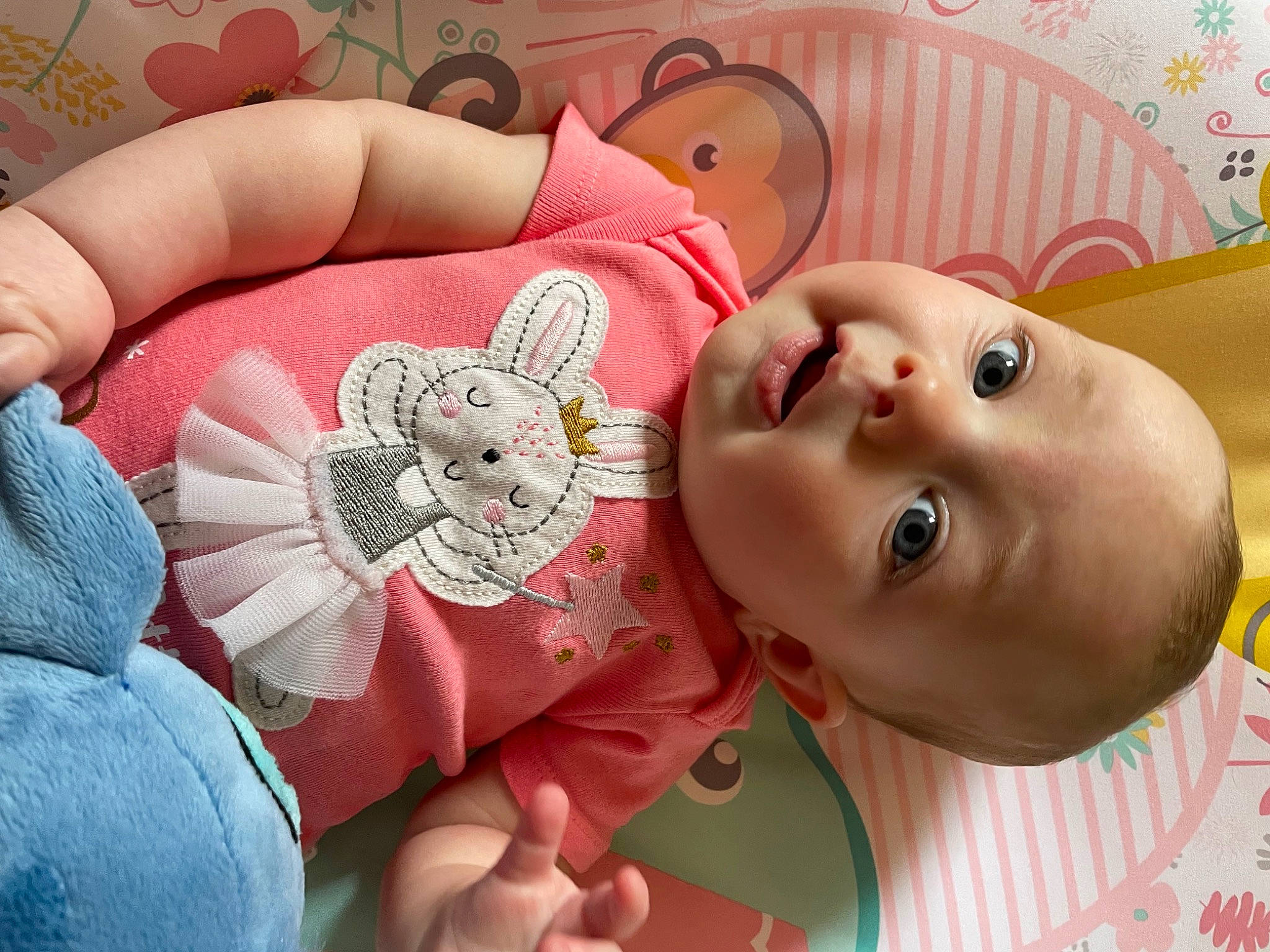 Fiona is registered to the contest to win money with this photo: cheek, child, eye, eyelash, finger, happy, head, headgear, joint, lip, mouth, neck, nose, orange, organ, person, pink, skin, textile, toy