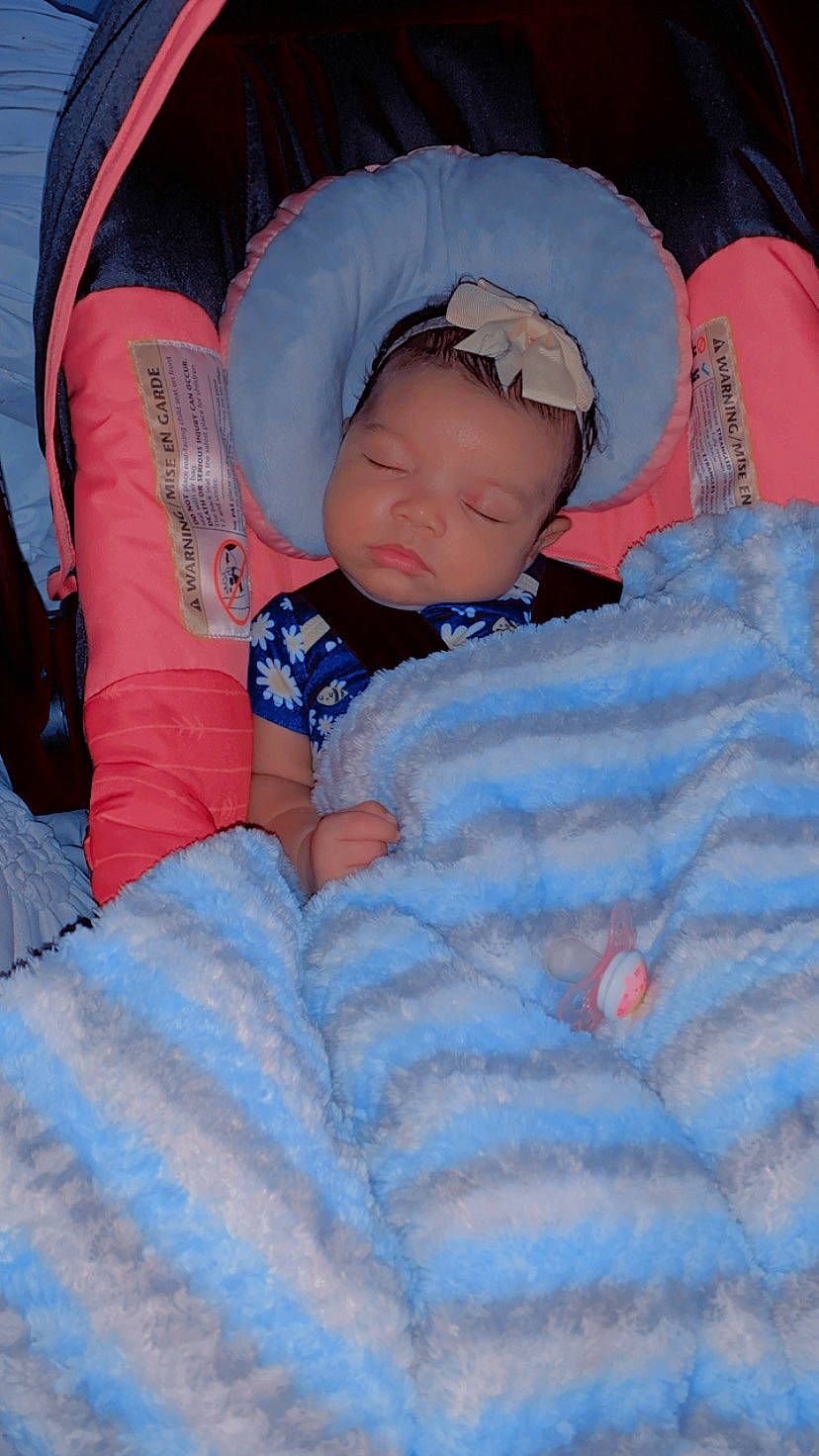 Londyn is registered to the contest to win money with this photo: baby, baby_products, baby_sleeping, baby_toddler_clothing, bedtime, carmine, cheek, child, comfort, electric_blue, eye, fun, human_body, lap, linens, nap, pattern, person, sitting, sleeve