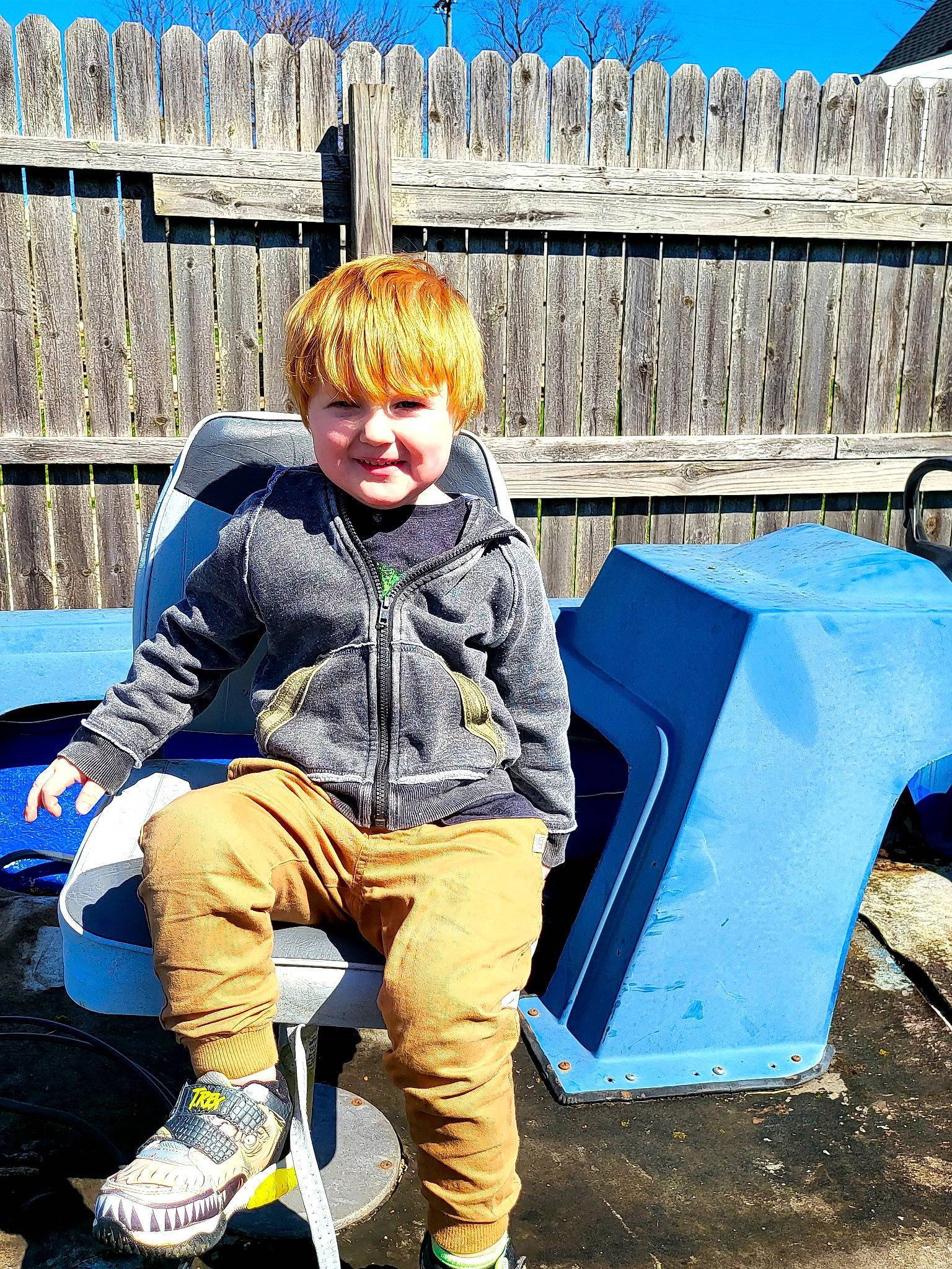 Ezekiel joined the competition — help win amazing prizes! blond, blue, daytime, denim, electric_blue, fence, fun, grass, happy, joy, leg, leisure, people_in_nature, person, shoe, sitting, sky, smile, sneakers, street_fashion