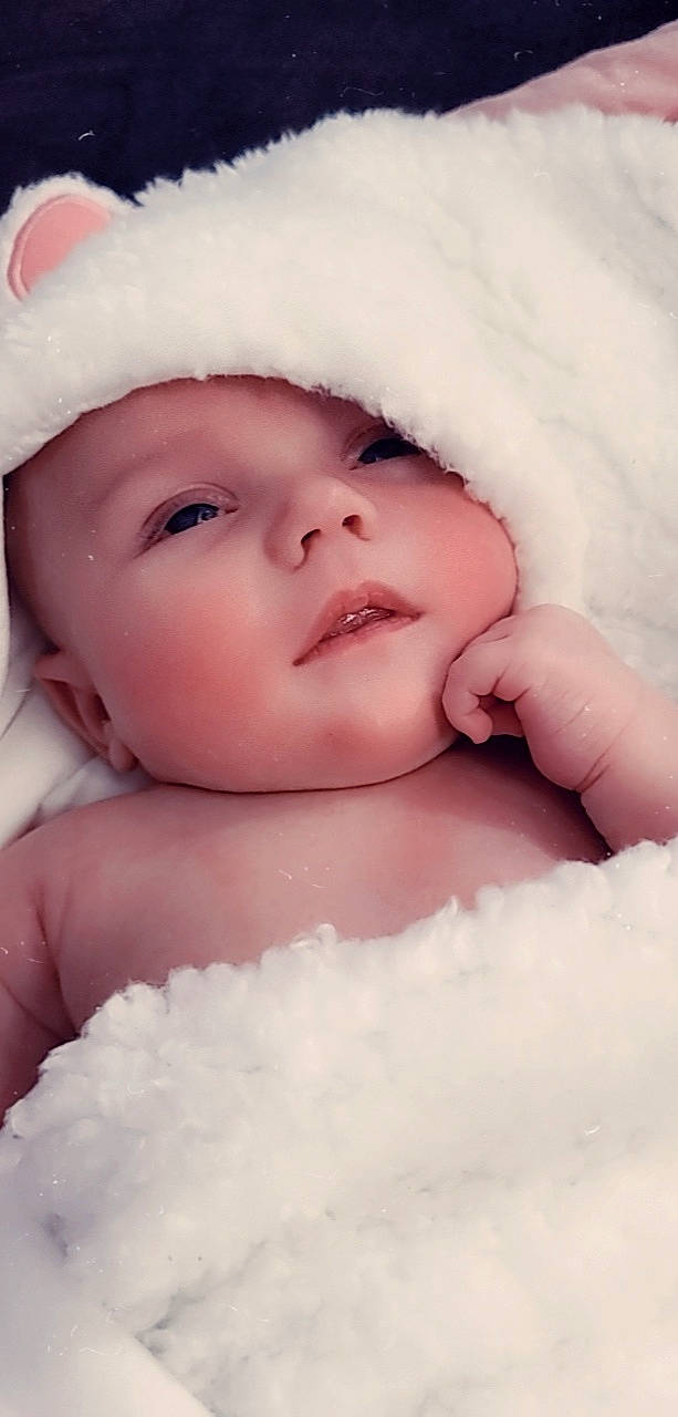 Matilda is registered to the contest to win money with this photo: baby, cap, cheek, chin, comfort, eye, eyebrow, eyelash, face, finger, gesture, happy, headgear, headwear, iris, lip, mouth, nose, person, skin