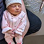 newborn, baby, sleeping, pink_onesie, hat, arms, adult, holding, peaceful, cozy, infant, cute, soft, resting, portrait, indoor, person, closeup, child, toddler