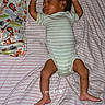 baby, sleeping, infant, bed, blanket, bottle, onesie, striped, peaceful, cute, child, resting, indoors, toddler, soft, comfort, lying_down, sleepwear, young, person