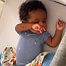 Larry is registered to the contest to win money with this photo: baby, infant, sleeping, blanket, crib, blue_clothing, curly_hair, arm, hand, face, child, indoor, cozy, resting, cute, soft_texture, patterned_blanket, animal_print, toddler, peaceful