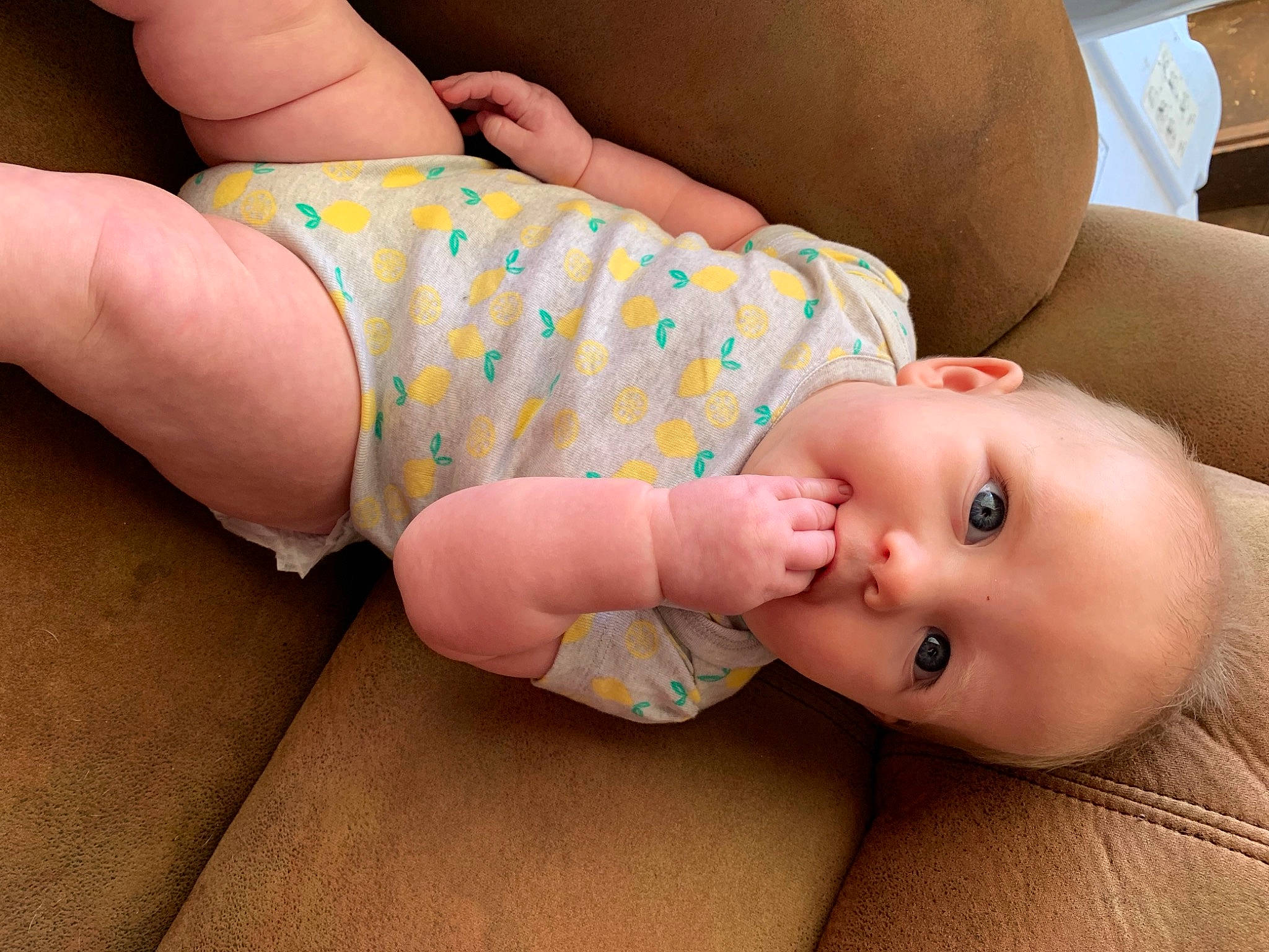 Lilly is registered to the contest to win money with this photo: baby, baby_toddler_clothing, cheek, comfort, eye, finger, foot, grass, headgear, human_leg, joint, knee, leg, mouth, nail, neck, organ, person, skin, thigh