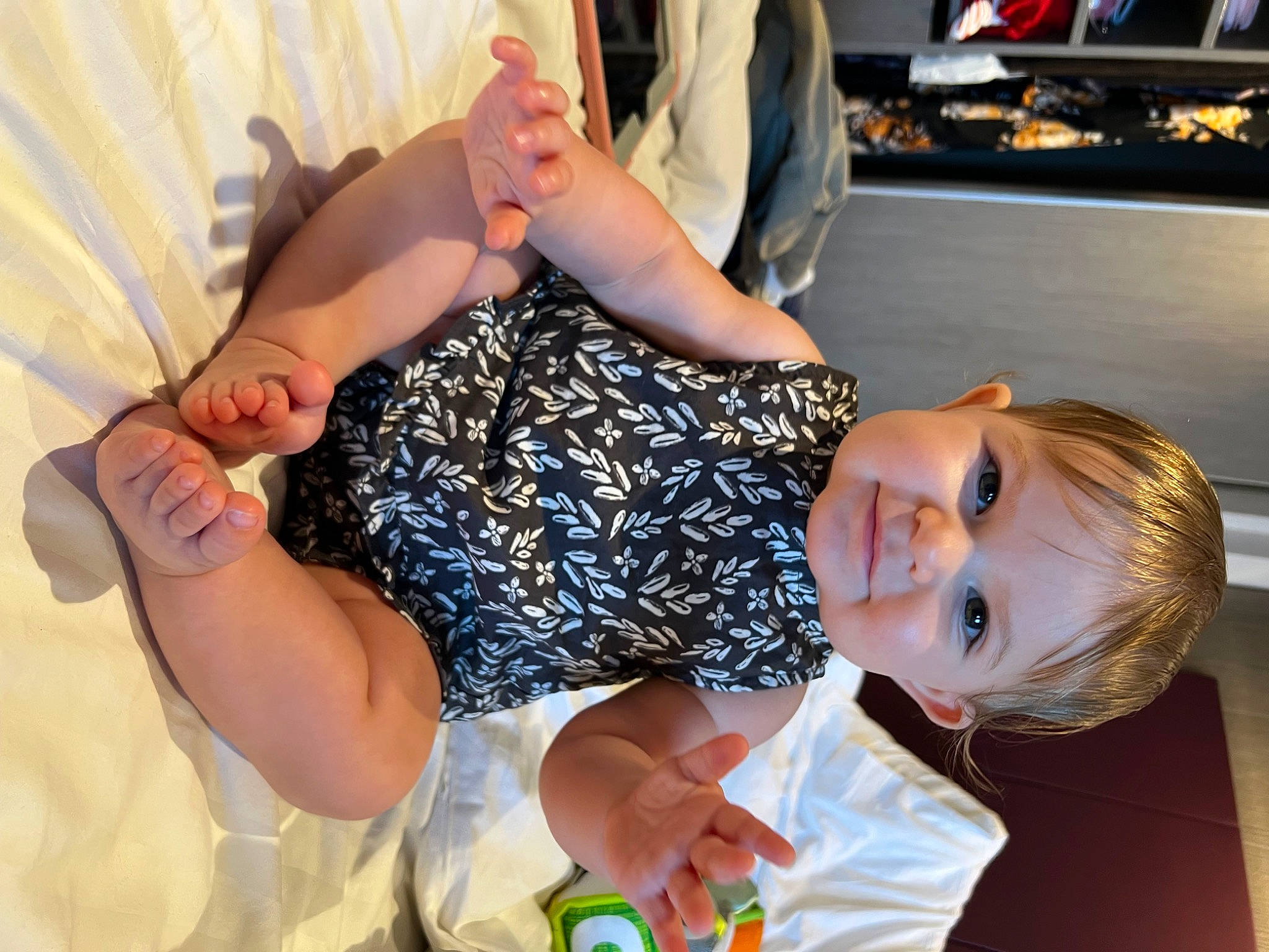 Emerie is registered to the contest to win money with this photo: baby_toddler_clothing, child, comfort, curtain, event, finger, fun, gesture, happy, human_leg, leisure, nail, person, sitting, smile, thigh, thumb, toddler, vacation, wrist