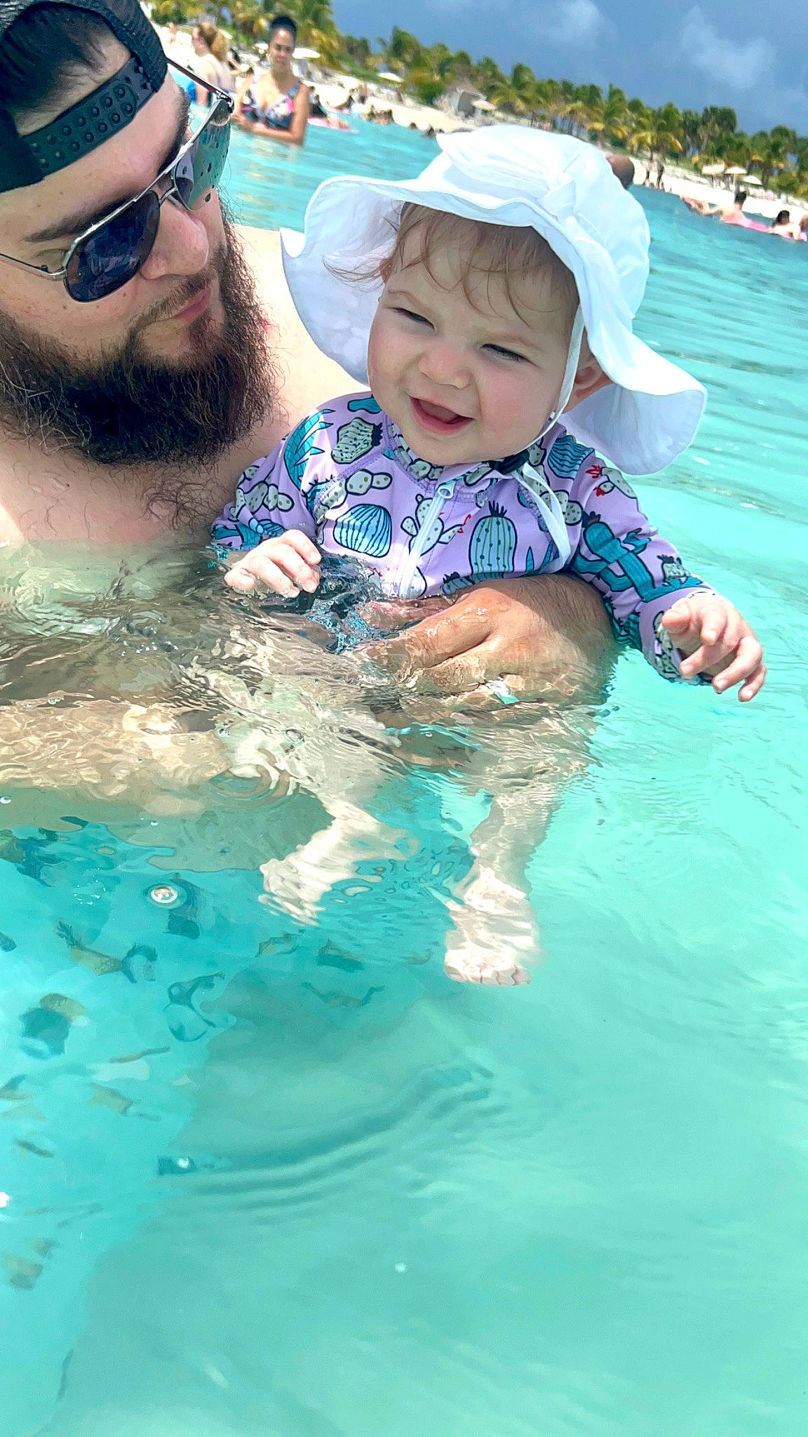 Emerie is registered to the contest to win money with this photo: bathing, beard, blue, cap, child, cool, facial_expression, fun, glasses, goggles, happy, hat, headwear, human, leisure, people, person, smile, sunglasses, swimming_pool