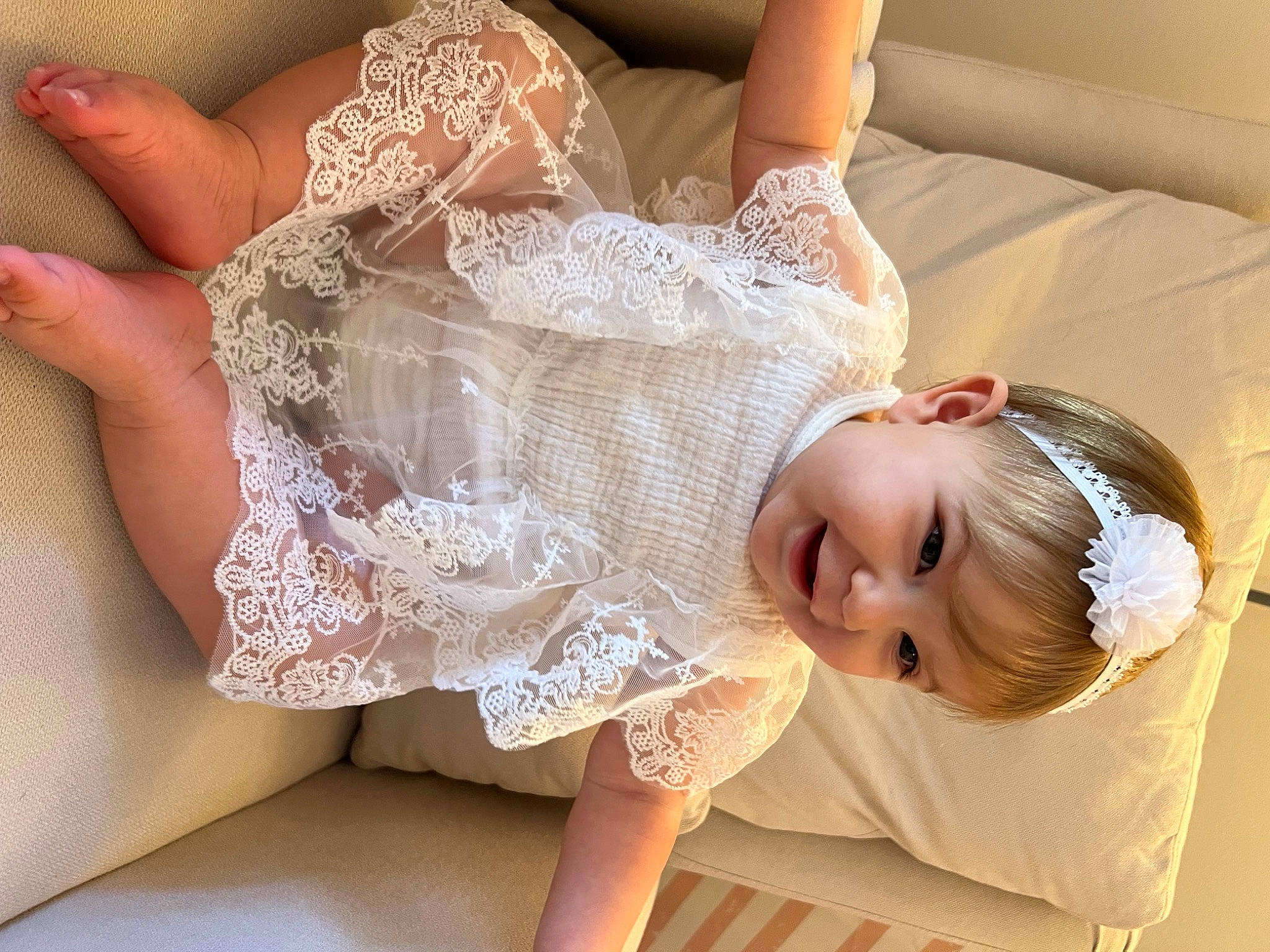 Emerie is registered to the contest to win money with this photo: baby_toddler_clothing, bridal_accessory, comfort, day_dress, elbow, embellishment, fashion_accessory, finger, flash_photography, gesture, hair_accessory, happy, headpiece, human_leg, joint, joy, person, skin, thigh, toddler