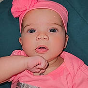 Luna joined the competition — help win amazing prizes! apparel, baby, child, closeup, curious, cute, expression, eyes, face, hand, head, indoors, infant, mouth, person, pink_clothing, pink_headband, portrait, skin, toddler