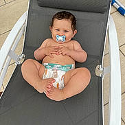 Alessio participe au concours pour gagner de l'argent avec cette photo : baby, pacifier, diaper, chair, outdoor, happy, smiling, infant, cute, relaxed, child, skin, legs, hands, head, hair, footwear_none, mesh, seat, playful