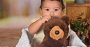 Casey is registered to the contest to win money with this photo: baby, blanket, brown_bear, child, cozy, cute, flowers, home, indoor, looking_at_camera, nursery, photography, plants, portrait, sitting, stuffed_animal, teddy_bear, toddler, white_blanket, wooden_furniture