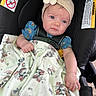Liyana is registered to the contest to win money with this photo: arm, baby, blanket, blue_eyes, buckle, car_seat, cartoon_print, cute, denim_dress, floral_embroidery, flower_headband, hand, harness, headband, infant, minnie_mouse_print, portrait, seat_padding, warning_label, young_child