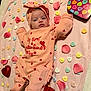 Liyana is registered to the contest to win money with this photo: baby, infant, valentines_day, onesie, bow_headband, blanket, conversation_hearts, rose_petals, heart_shaped_box, balloon, pink, hearts, portrait, lying_down, cute, newborn, face, clothing, holiday, celebration