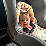 baby, blanket, buckle, car_interior, car_seat, clothing, cute, eyes, face, floral_pattern, hand, headrest, infant, newborn, pacifier, portrait, safety, seat_belt, smiling, window