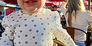 Josie is registered to the contest to win money with this photo: adult, baby, bodypart, chair, clothing, face, female, finger, footwear, furniture, hand, head, indoors, person, photography, portrait, restaurant, shoe, sitting, woman