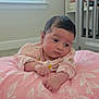 baby, infant, pink_cushion, leaf_pattern, onesie, indoor, window, blinds, crib, carpet, face, hands, curious, soft_lighting, home_interior, baby_clothing, newborn, child, person, portrait