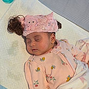 Taryn is registered to the contest to win money with this photo: baby, sleeping, pink_clothing, headband, hair_buns, blanket, pacifier, infant, cute, peaceful, soft_lighting, indoors, face, child, pajamas, newborn, resting, floral_pattern, baby_girl, cozy
