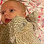 Callia joined the competition — help win amazing prizes! baby, infant, face, eyes, mouth, leopard_print, clothing, blanket, pattern, soft_texture, cute, lying_down, newborn, child, skin, head, ear, expression, indoors, fabric