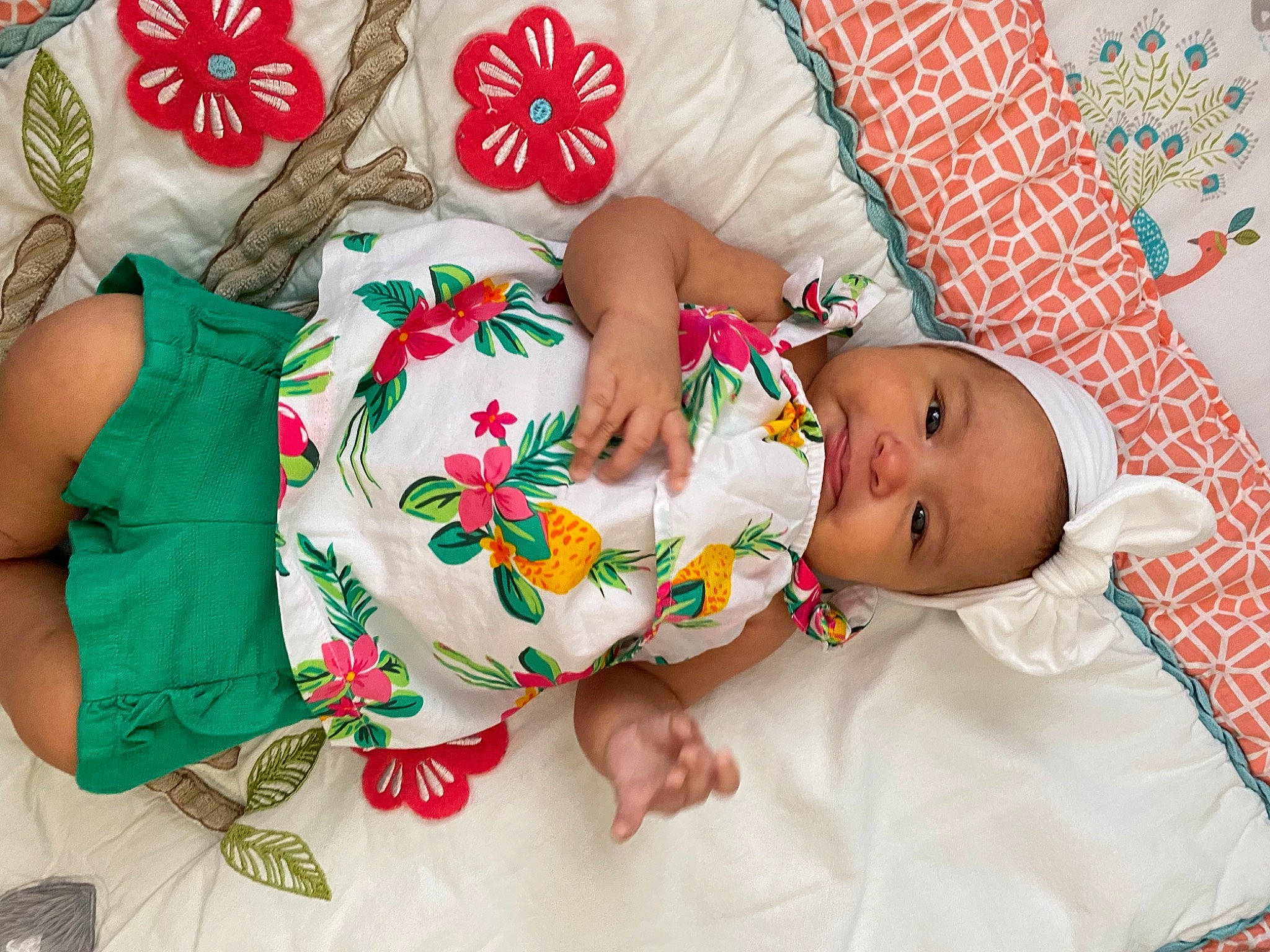 Maxine is registered to the contest to win money with this photo: baby, baby_products, baby_toddler_clothing, child, comfort, design, dress, event, face, finger, headwear, human_leg, linens, pattern, person, red, skin, sleeve, textile, thigh