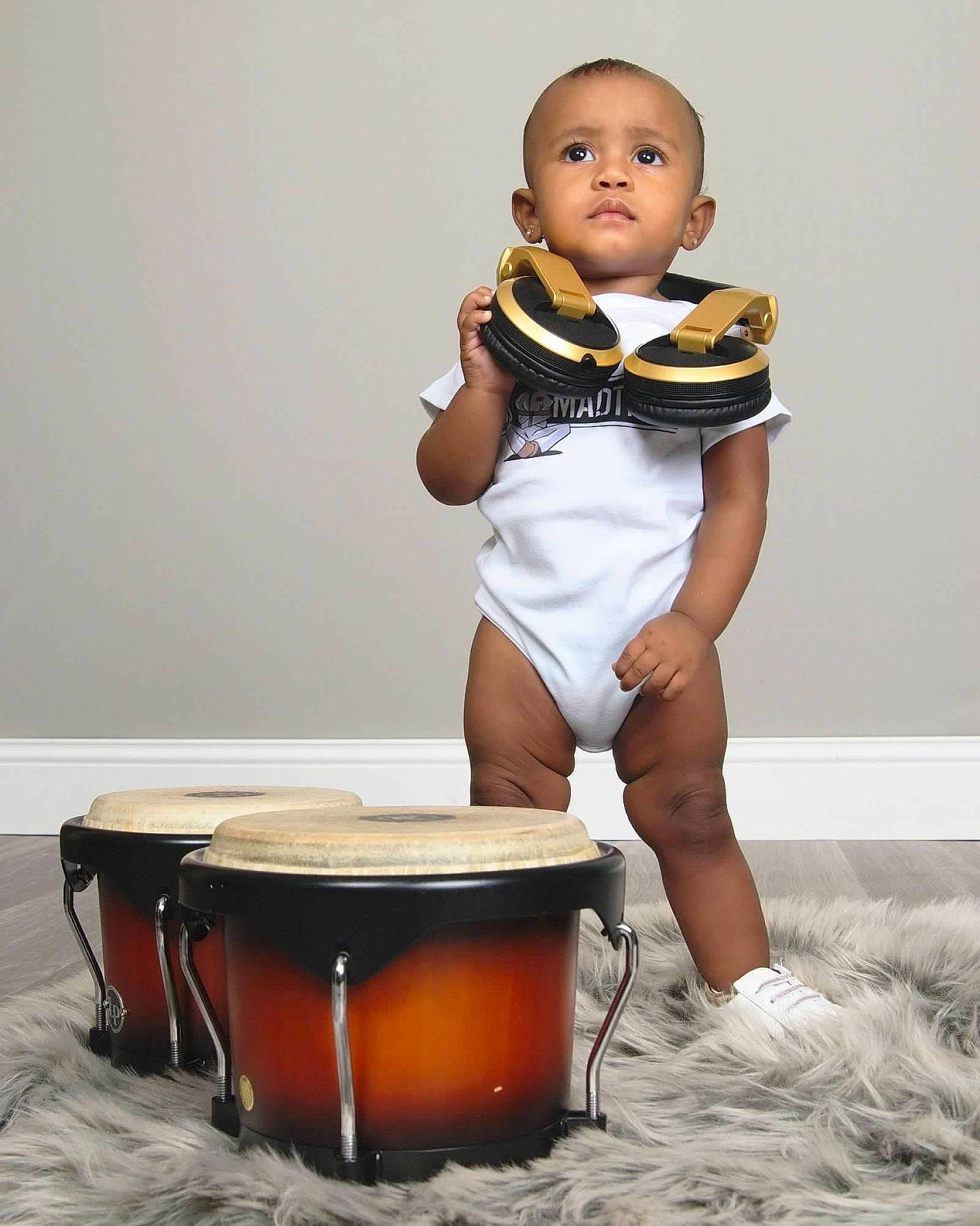 Karoline joined the competition — help win amazing prizes! abdomen, baby, baby_toddler_clothing, chest, drum, flash_photography, foot, happy, human_body, human_leg, knee, membranophone, musical_instrument, person, personal_protective_equipment, sitting, sleeve, stomach, thigh, toddler