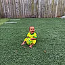 Kayden is registered to the contest to win money with this photo: artificial_grass, baby, brazil, child, football, happy, infant, outdoor, photography, playful, portrait, sitting, smiling, soccer, soccer_ball, sports, sportswear, turf, wooden_fence, yellow_clothing