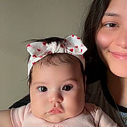 Auriel joined the competition — help win amazing prizes! baby, infant, headband, pink_shirt, bear_design, woman, smile, face, portrait, child, holding, closeup, indoor, person, cute, expression, skin, hair, childhood, family