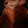baby, child, hood, orange, hearts, clothing, face, expression, cute, infant, person, portrait, smile, mouth, eye, warm, cozy, fabric, zipper, dark_background