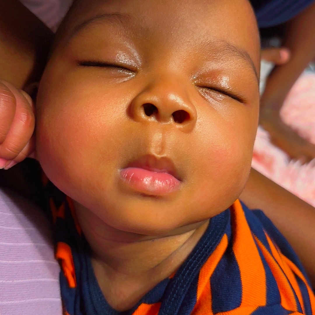 Evan joined the competition — help win amazing prizes! baby, bodypart, cap, clothing, cosmetics, face, finger, frown, hand, hat, head, lipstick, mouth, neck, newborn, person, photography, portrait, sad, sleeping