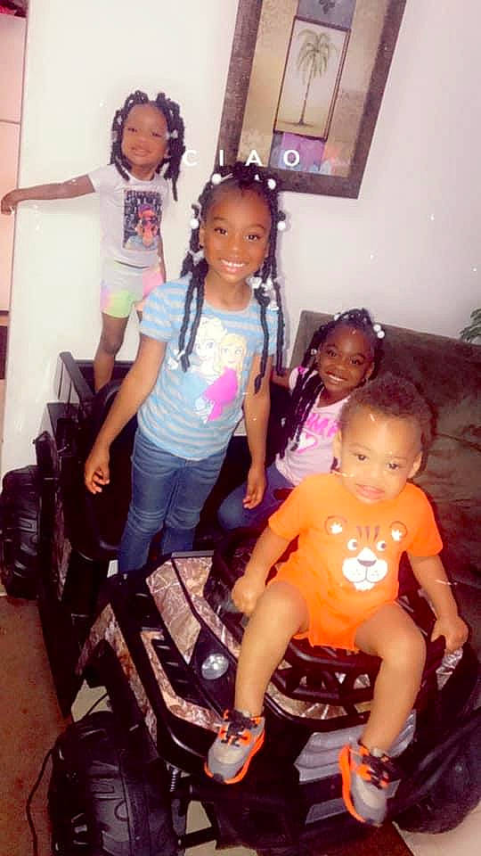 Dakota is registered to the contest to win money with this photo: automotive_tire, black, black_hair, cool, face, facial_expression, friendship, hair, happy, joy, lap, leisure, person, shorts, skin, smile, standing, summer, t_shirt, thigh