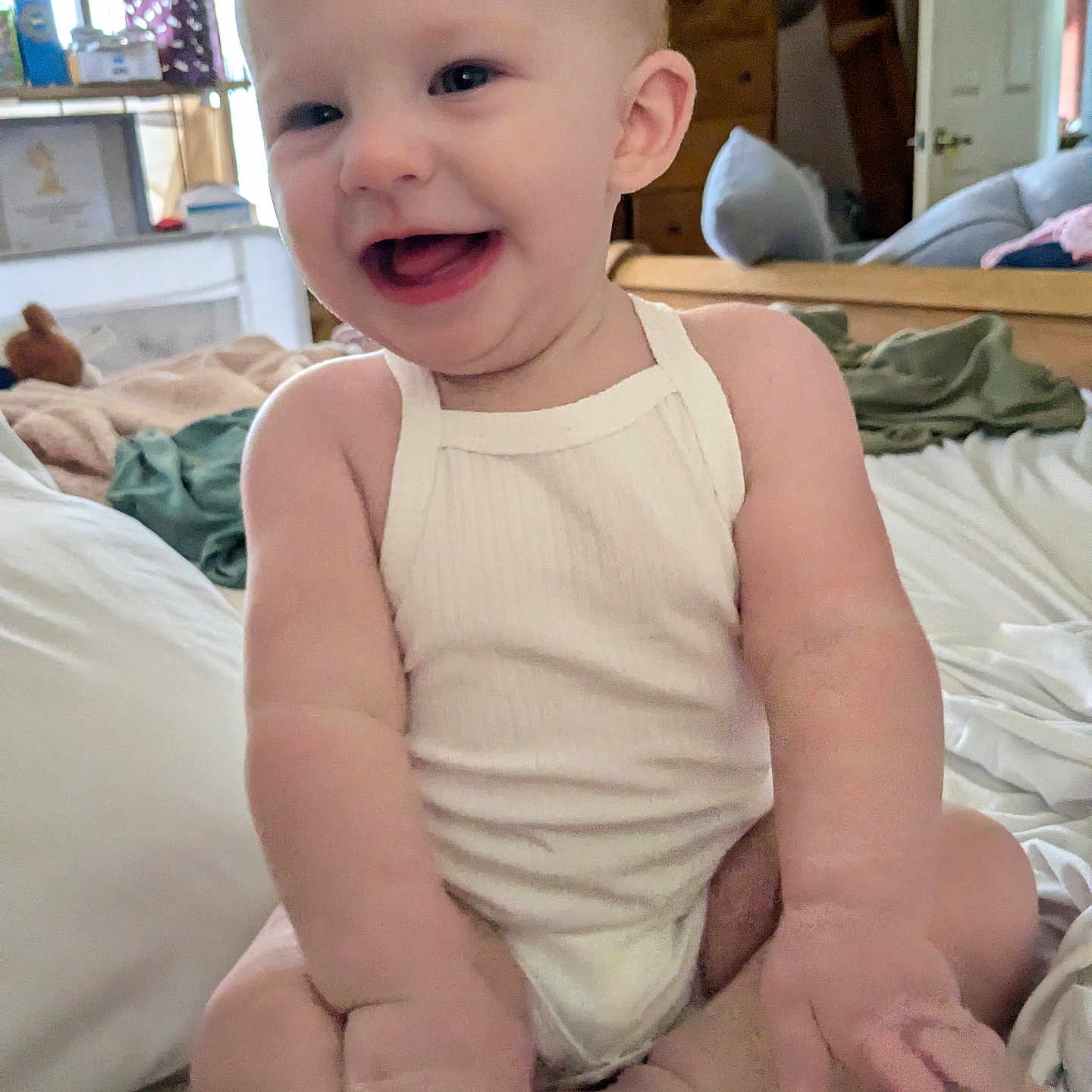 Ryan is registered to the contest to win money with this photo: accessories, baby, babylaughing, bag, bed, bedroom, bodypart, couch, face, finger, furniture, hand, happy, head, indoors, laughing, person, photography, portrait, room