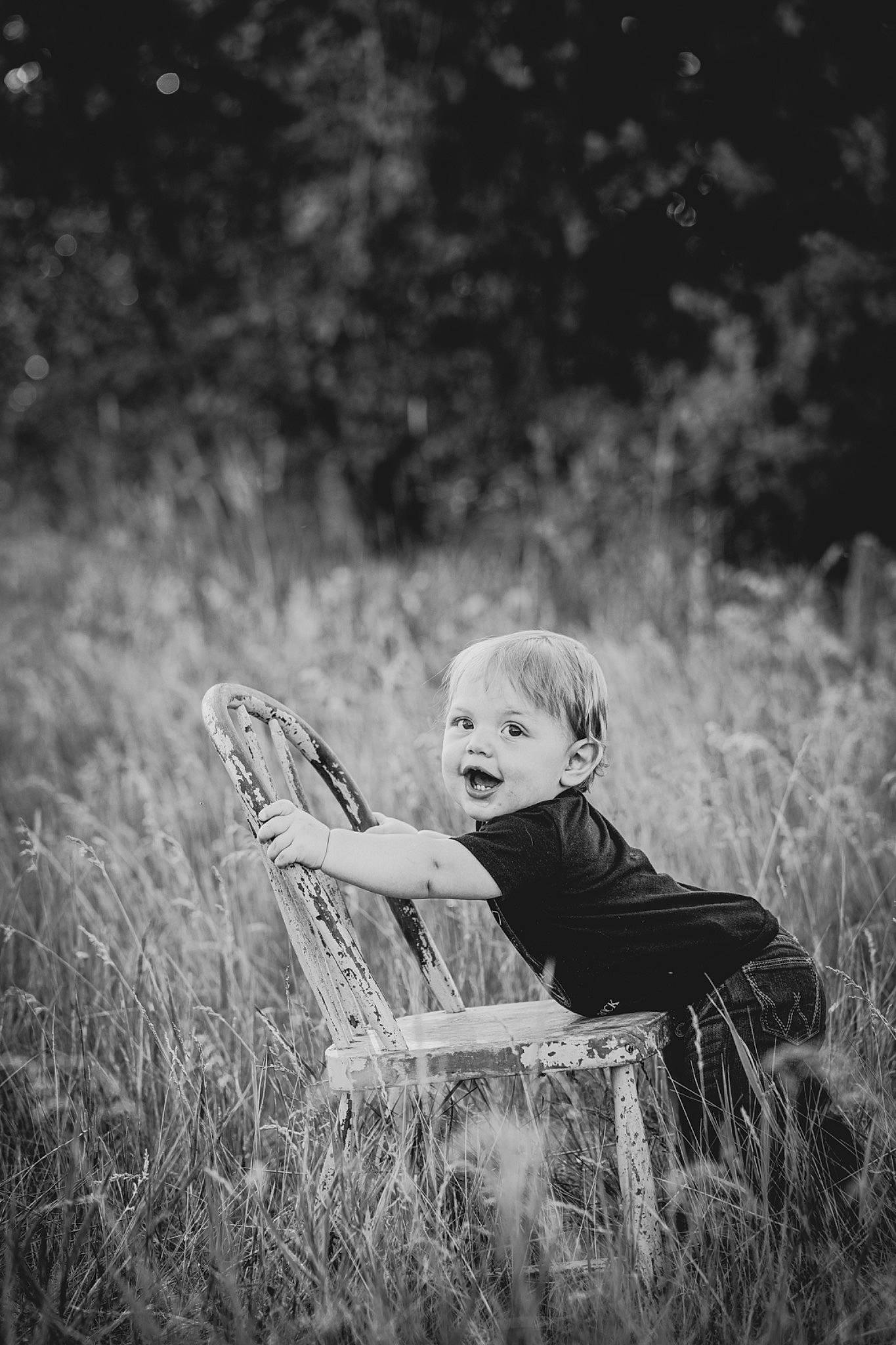 Bentley is registered to the contest to win money with this photo: black_and_white, chair, flash_photography, forest, grass, grassland, happy, meadow, monochrome, monochrome_photography, people_in_nature, person, plant, prairie, sitting, smile, style, tints_and_shades, toddler, tree