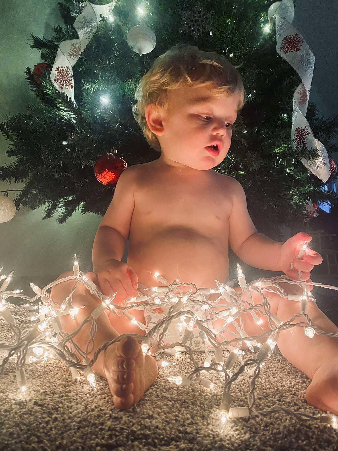 Bentley is registered to the contest to win money with this photo: abdomen, beauty, chest, child, christmas_ornament, cool, event, facial_expression, fictional_character, flash_photography, fun, happy, holiday, holiday_ornament, human_body, muscle, ornament, people_in_nature, person, toddler