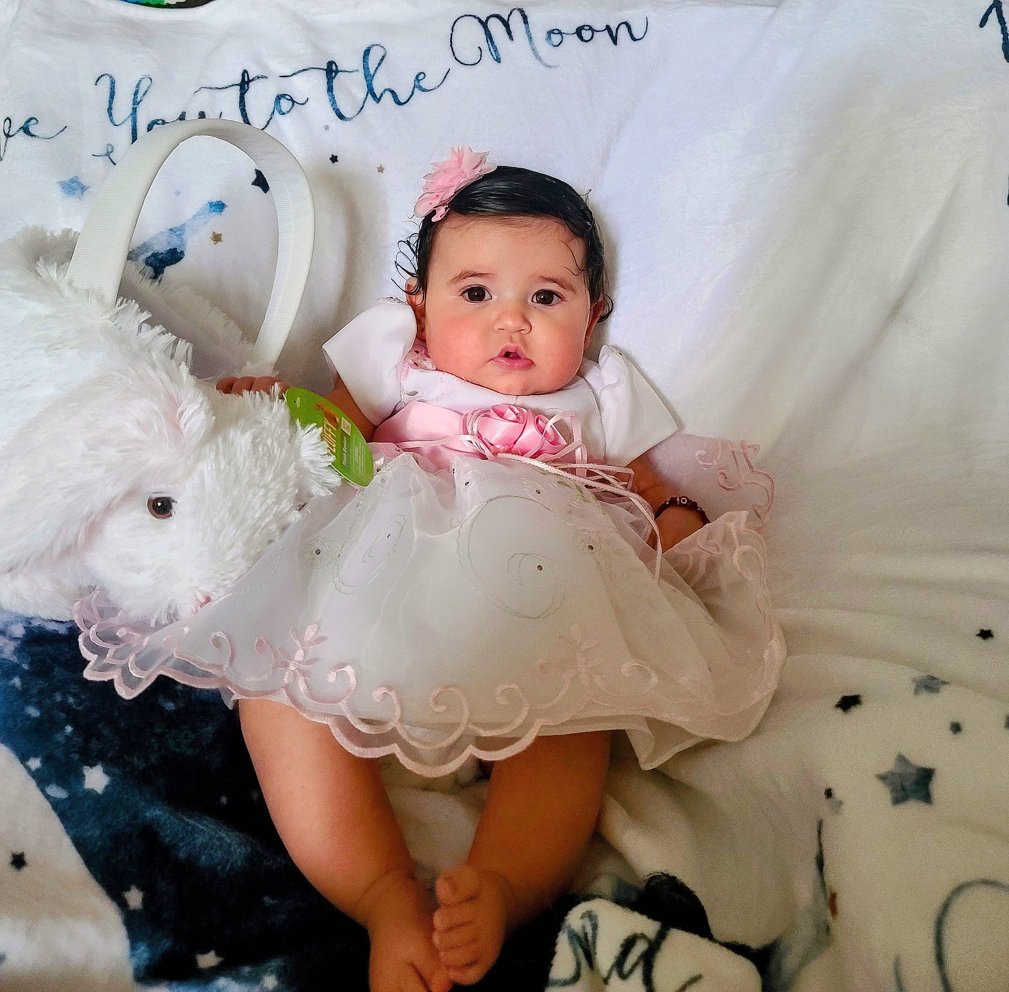 Camila is registered to the contest to win money with this photo: baby, baby_toddler_clothing, comfort, embellishment, eye, face, finger, flash_photography, gesture, hair_accessory, hand, happy, head, headgear, headpiece, person, pink, skin, sleeve, toddler