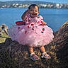 baby, blue_sky, child, cute, fashion, footwear, grass, happy, lake, nature, outdoor, people, pink_dress, portrait, sandals, smiling, summer, sunlight, tree_root, water