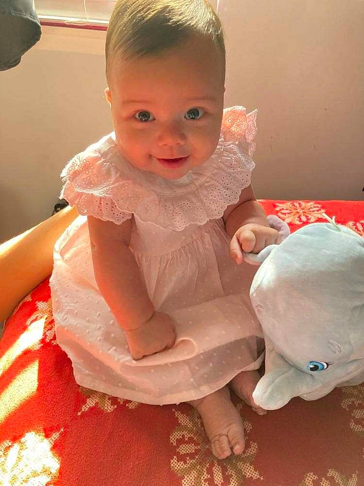 Liliana joined the competition — help win amazing prizes! arm, baby, baby_toddler_clothing, cheek, child, dress, finger, flooring, fun, hairstyle, hand, happy, human_body, joint, mouth, person, pink, skin, sleeve, smile